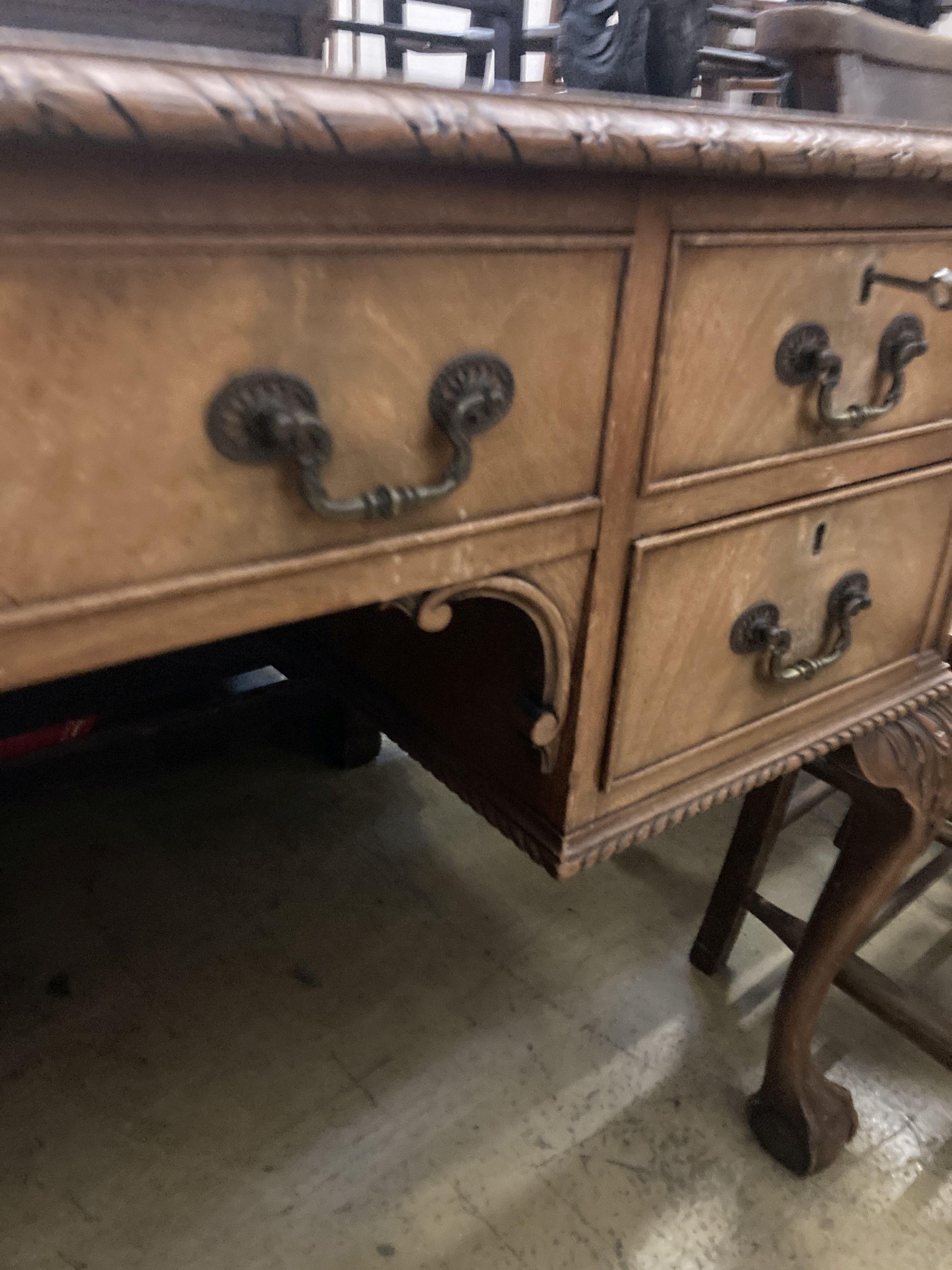 A Queen Anne revival mahogany kneehole desk, length 122cm, depth 76cm, height 76cm